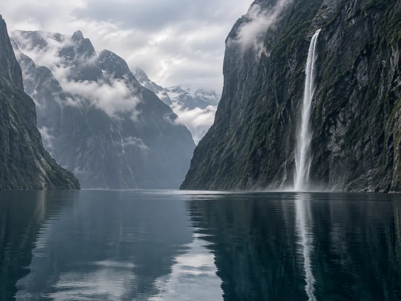 Mitre Peak rising above the still water of Milford Sound