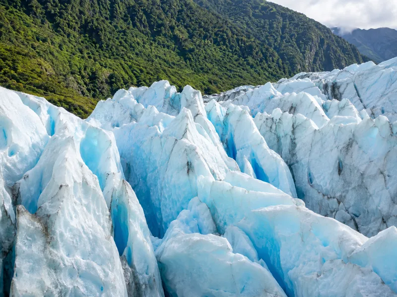 Franz Josef Glacier descending toward green rainforest