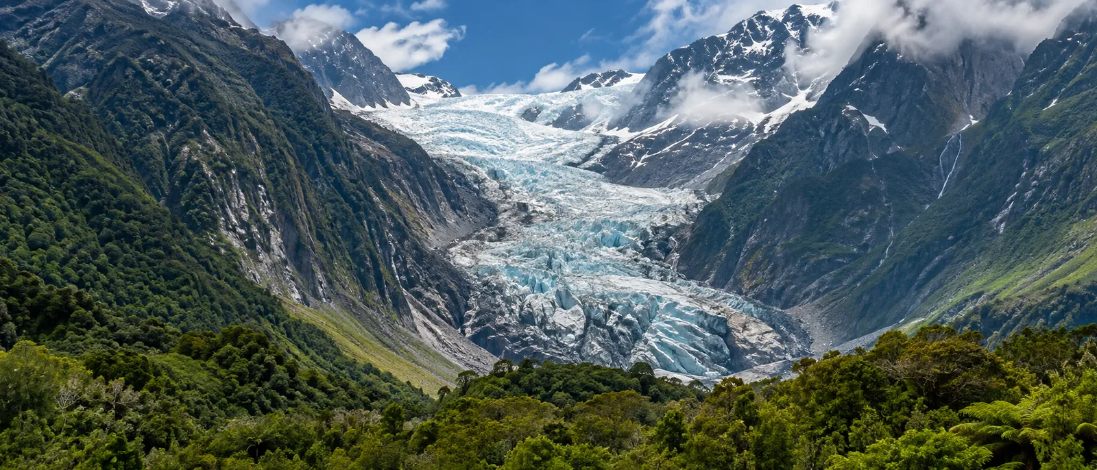 Franz Josef Glacier descending toward green rainforest